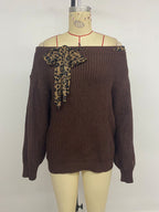 A long-sleeved sweater with a three-dimensional bow top
