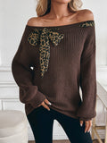 A long-sleeved sweater with a three-dimensional bow top